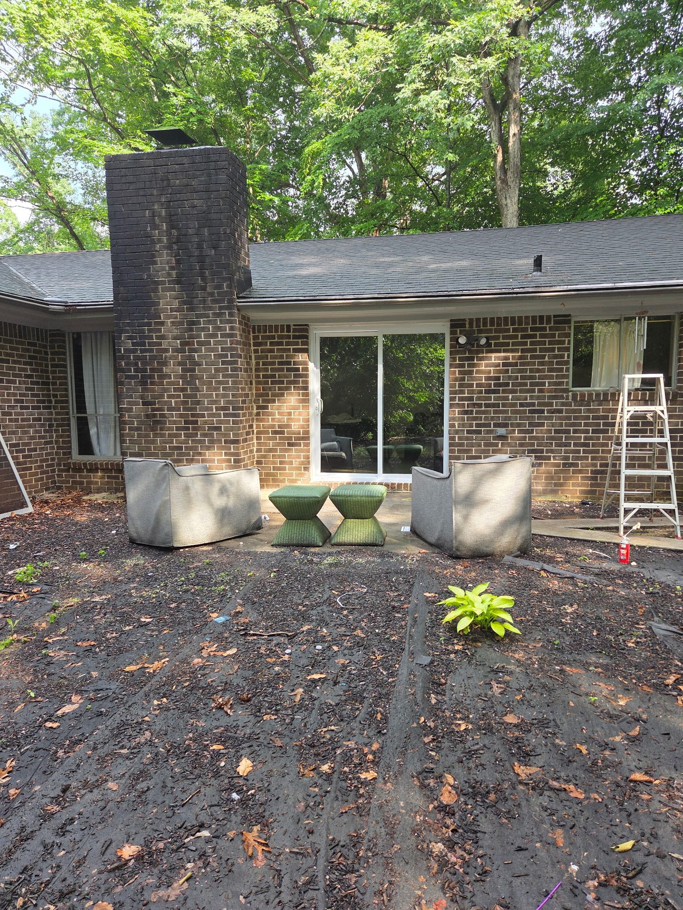 Finished backyard with new sliding glass door and patio area