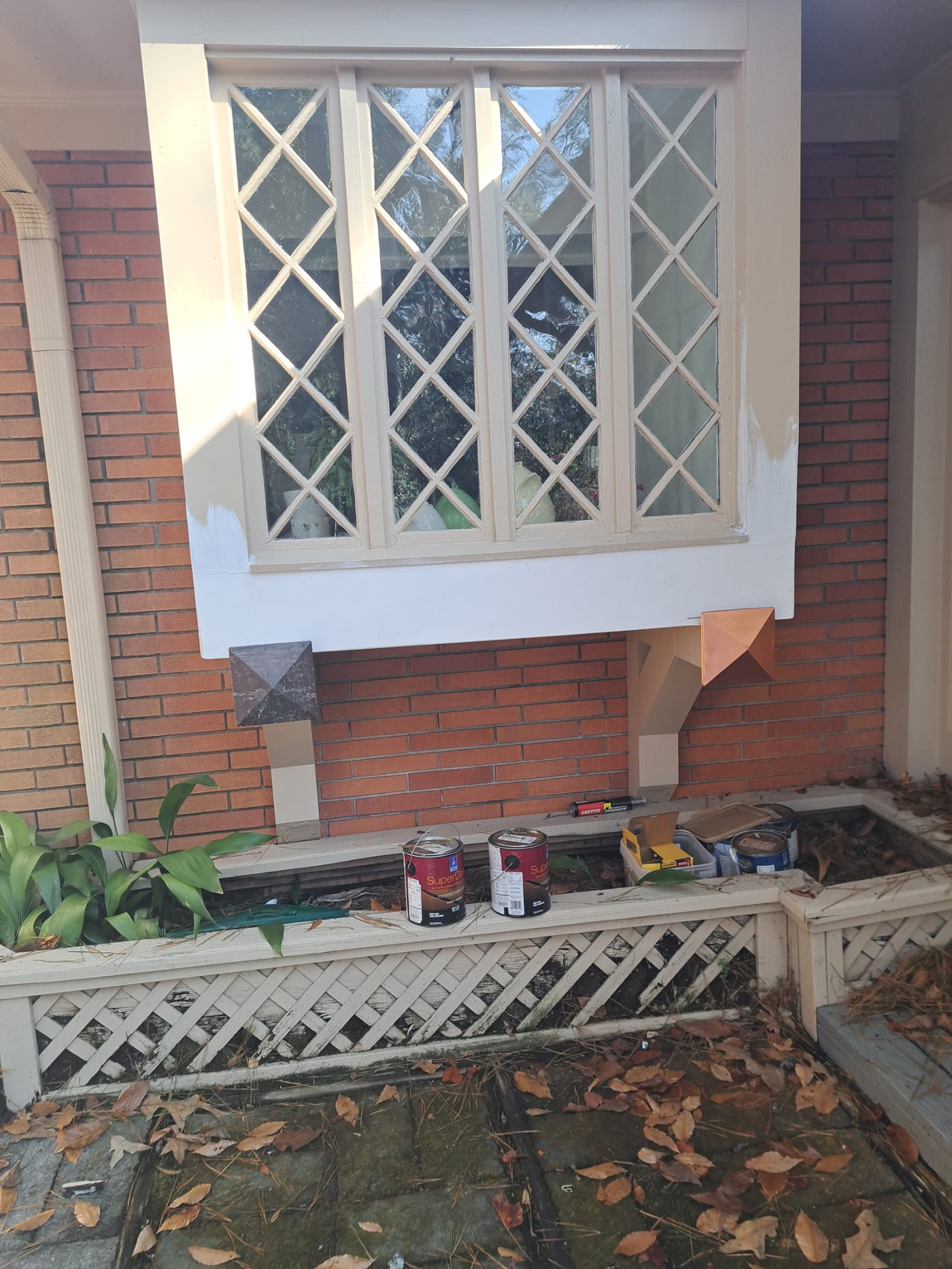 House exterior window and trim before painting with supplies out