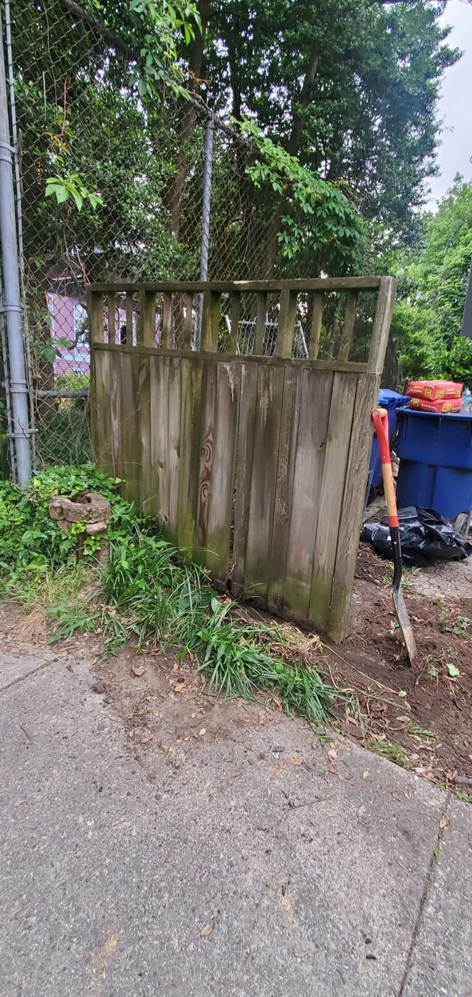 Old weathered gray fence before replacement