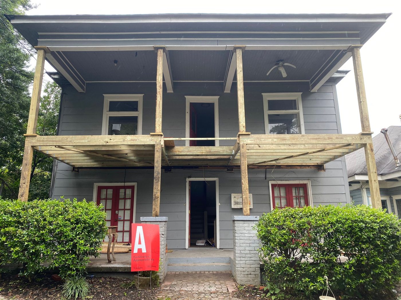 Two-story house under construction with raw wood framing